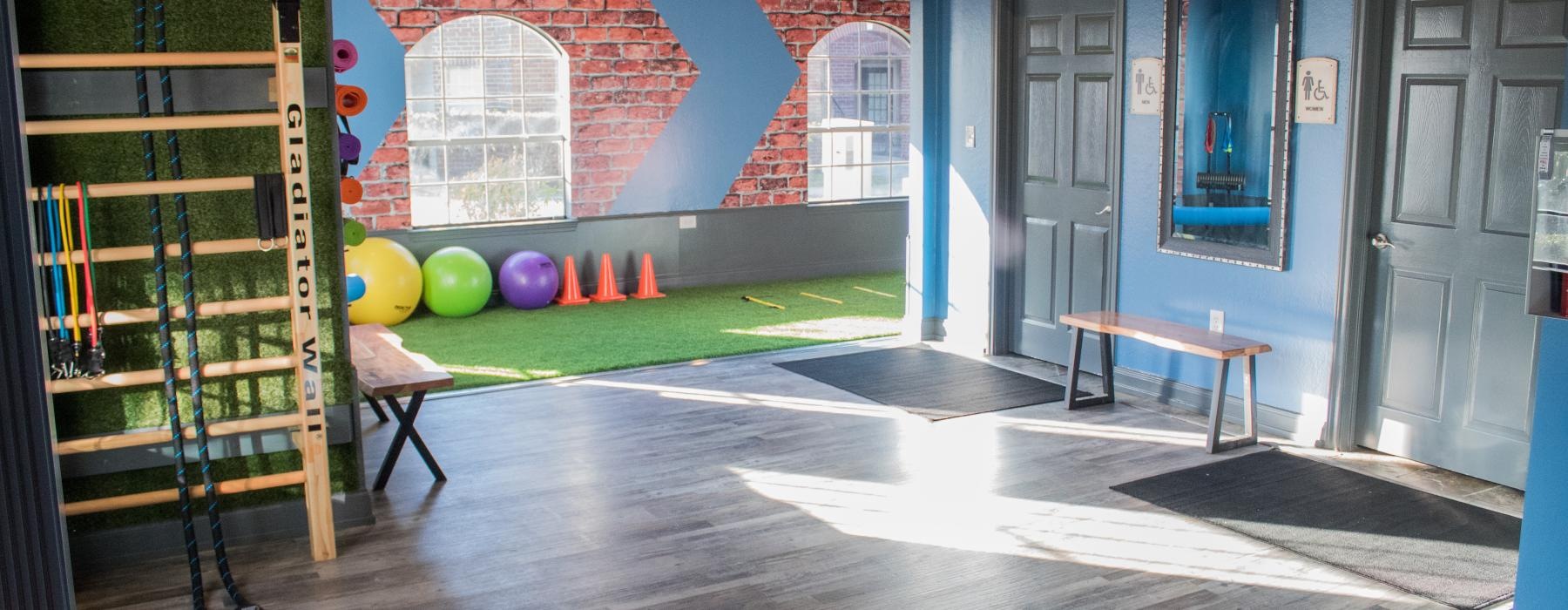 a room with a wood floor and a wood floor with a ladder and a table and a ball