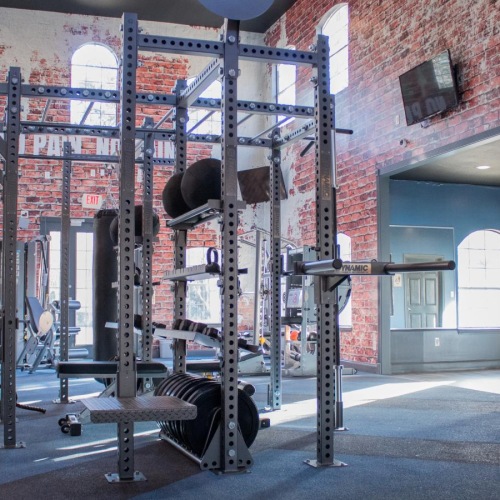a brick building with a large metal frame and a sign on the side