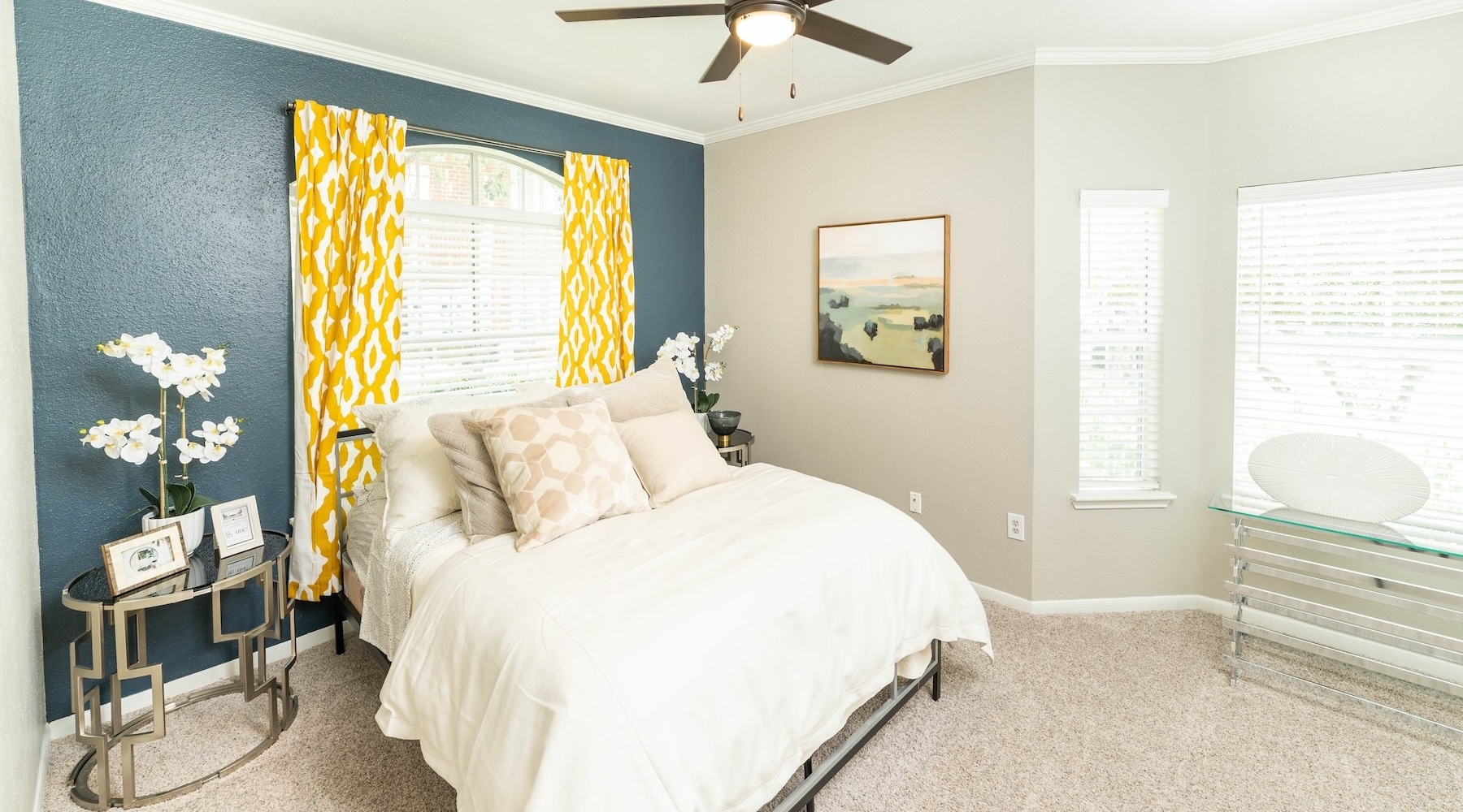 a bedroom with a bed and a fan