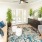 a living room with a rug and a chair