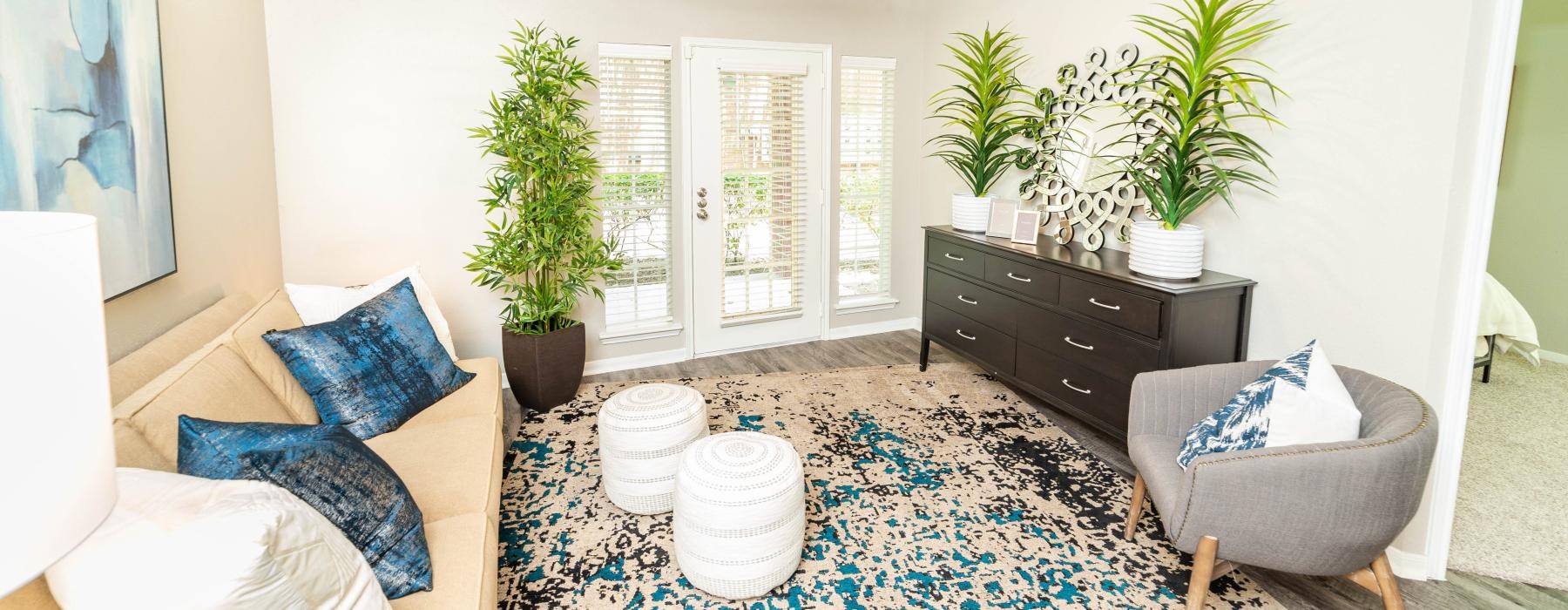 a living room with a rug and a chair