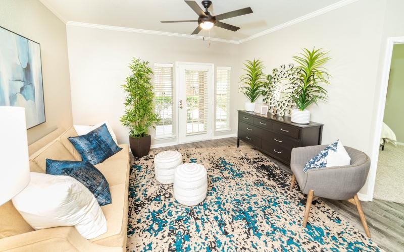 a living room with a rug and a chair