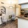 a kitchen with a bar and chairs
