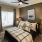 a bedroom with a bed and a fan