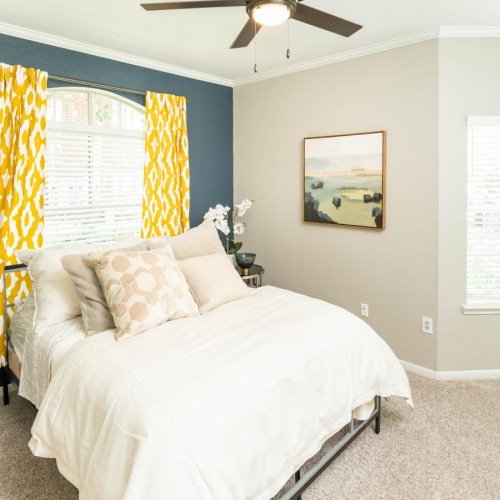 a bedroom with a bed and a fan