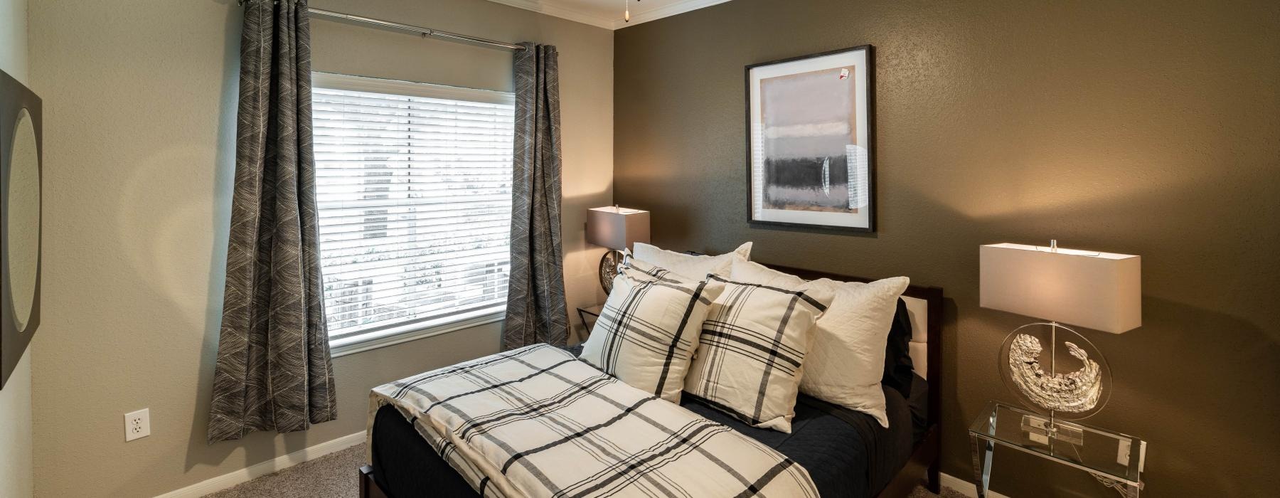 a bedroom with a bed and a fan